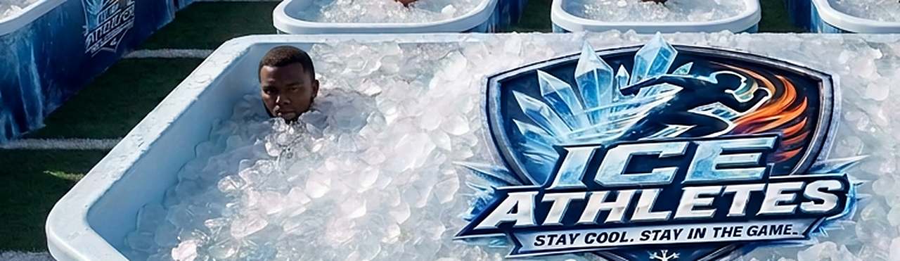 An athlete neck-deep in a tub of ice